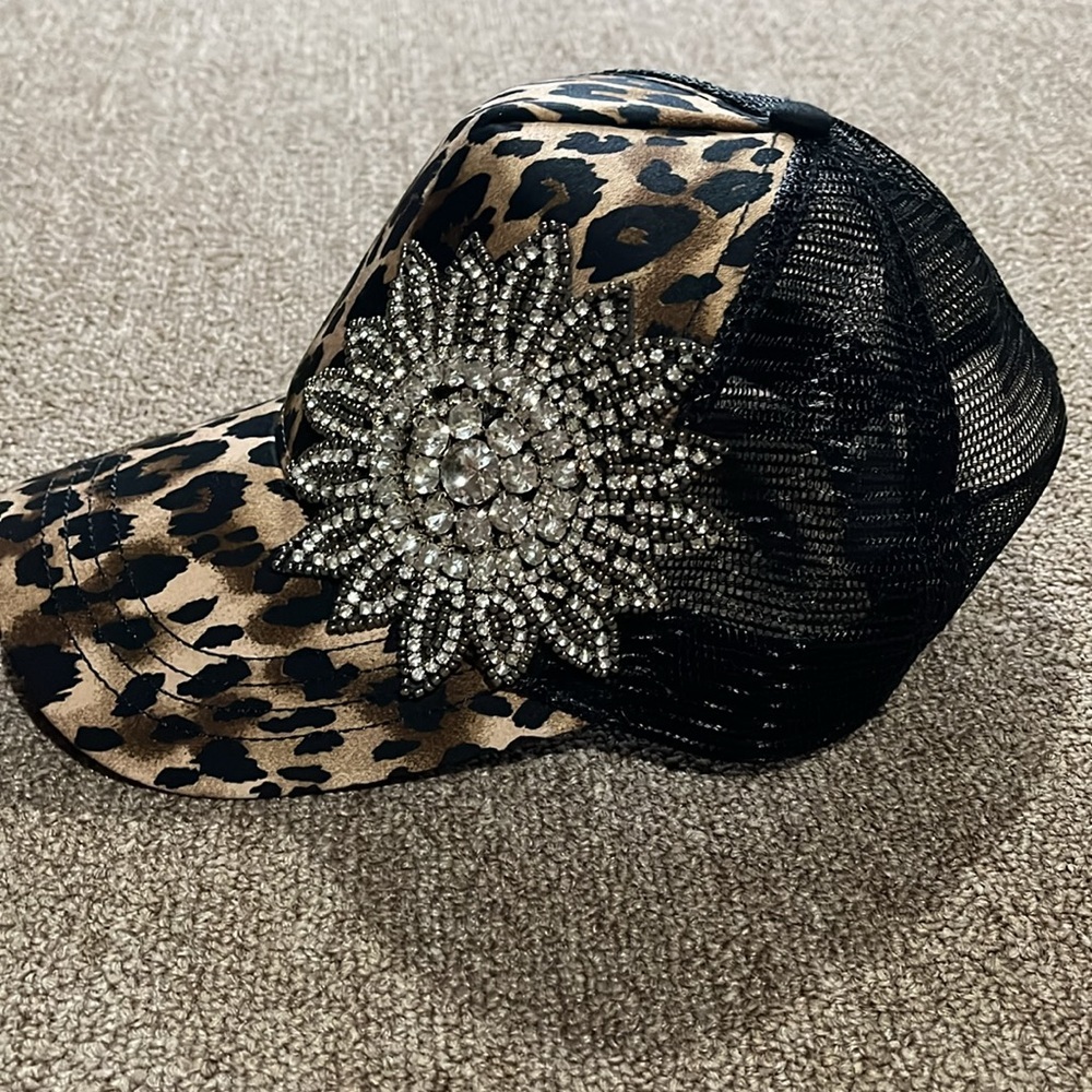 Leopard Cheetah print w/ bling trucker hat. Adjustable sizing. Ponytail opening.